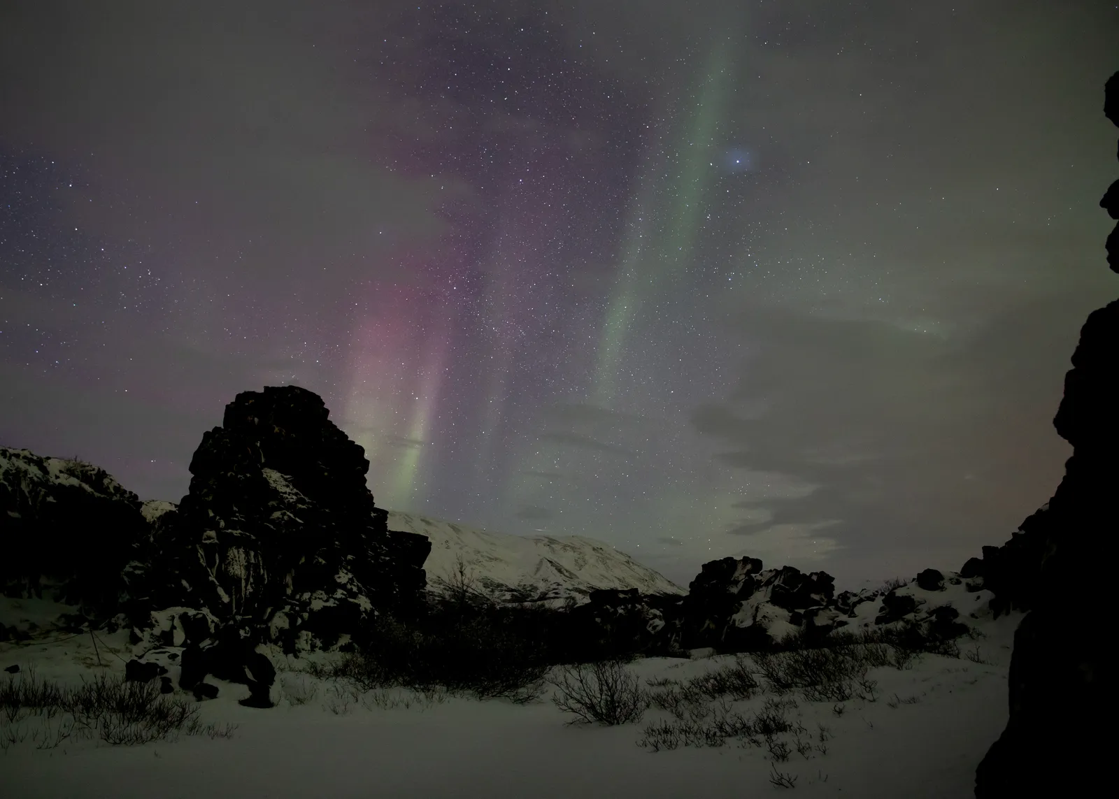 A faint aurora over a snowy Icelandic lava field — what a low-KP night can look like away from city lights