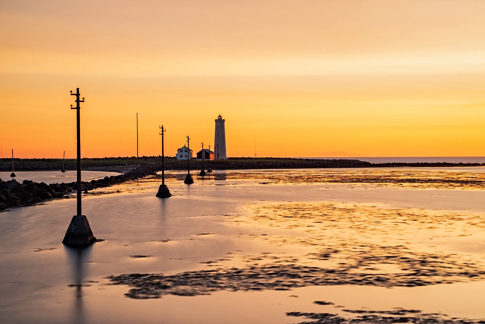 Grótta lighthouse at sunset — the tidal causeway floods at high tide, so check the tide times first