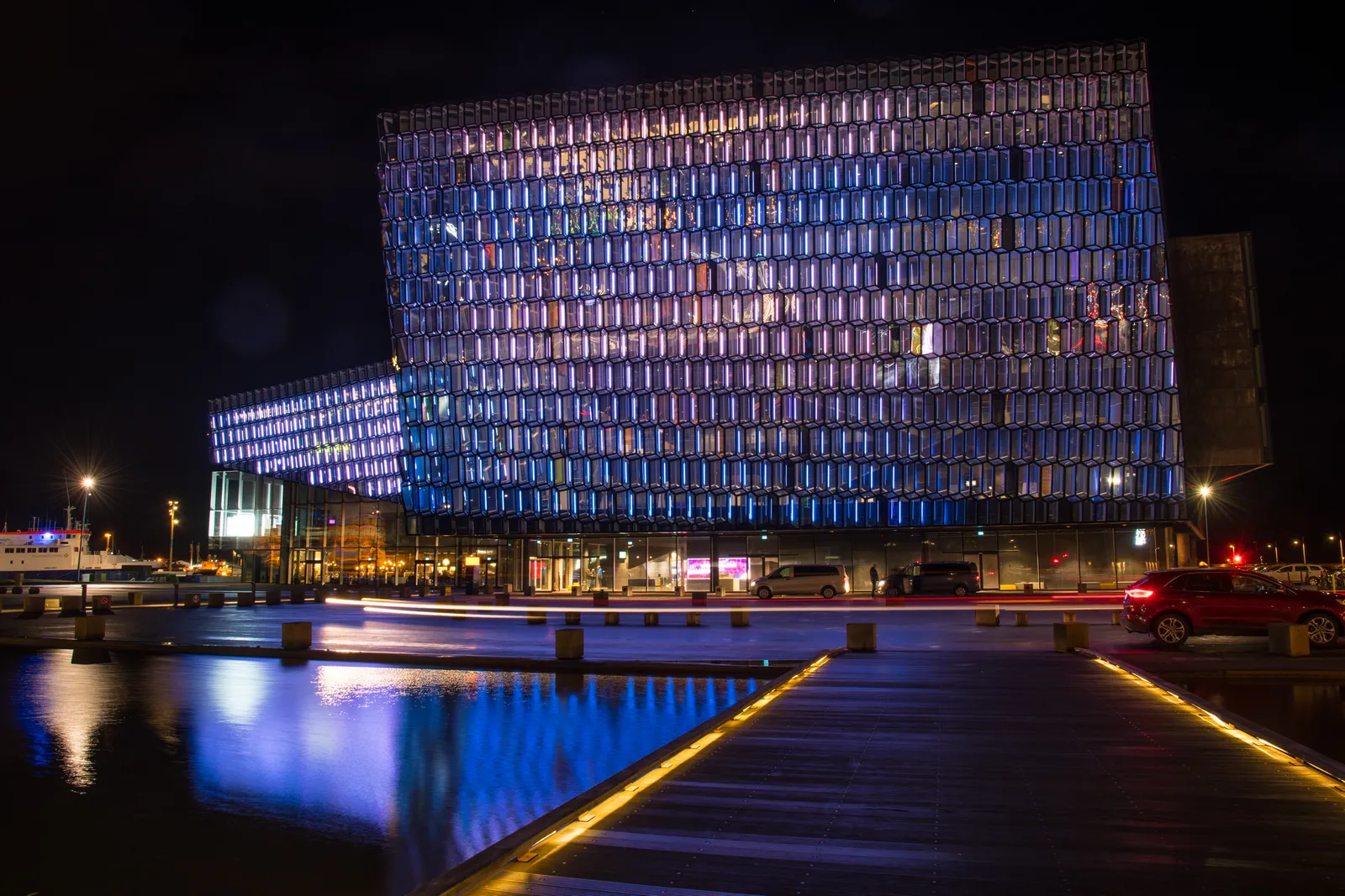 Harpa Concert Hall lit up in the evening — concerts run most nights, and same-day tickets are often available