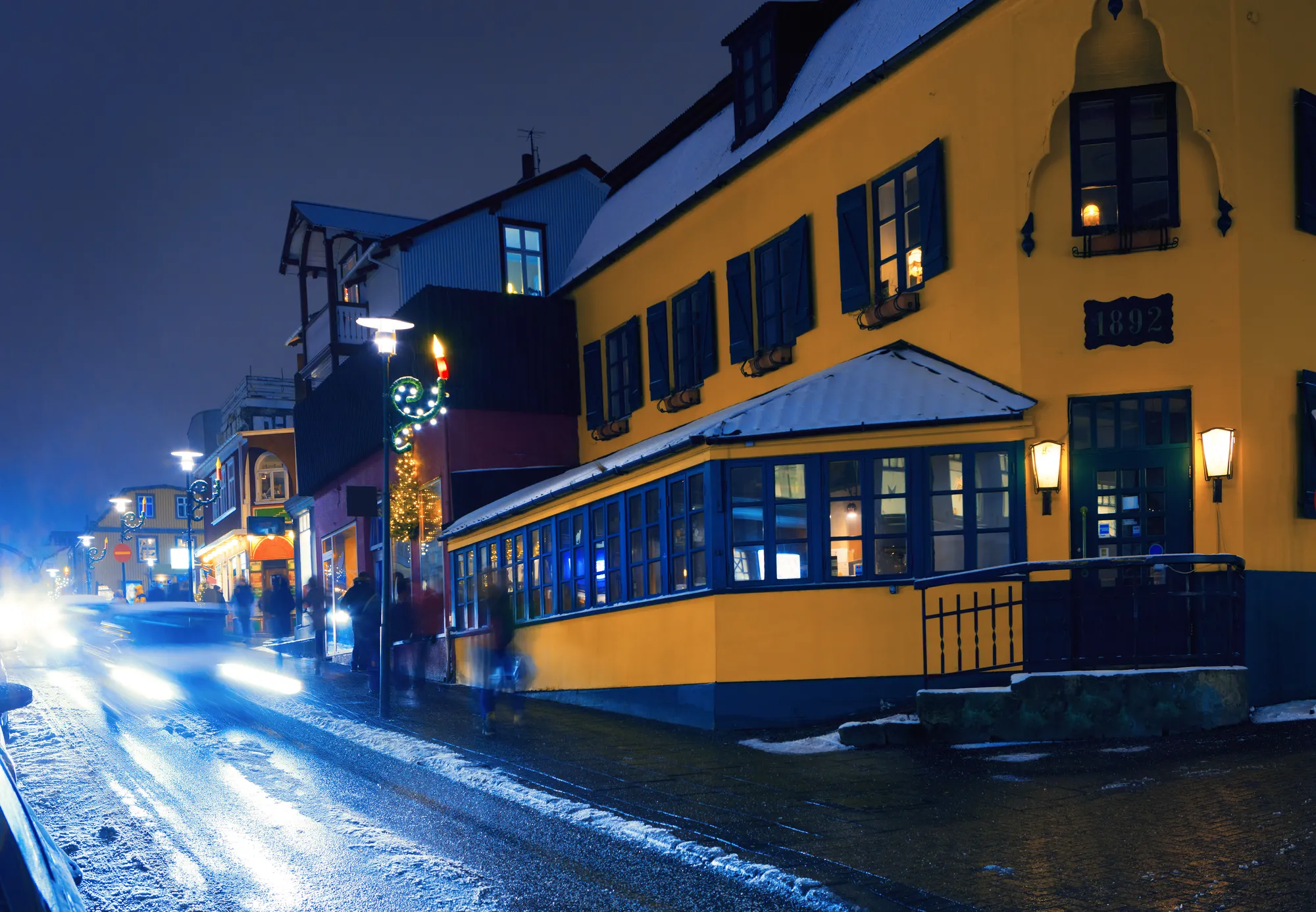 Laugavegur on a snowy winter evening — Reykjavík's main street stays lively every night of the week