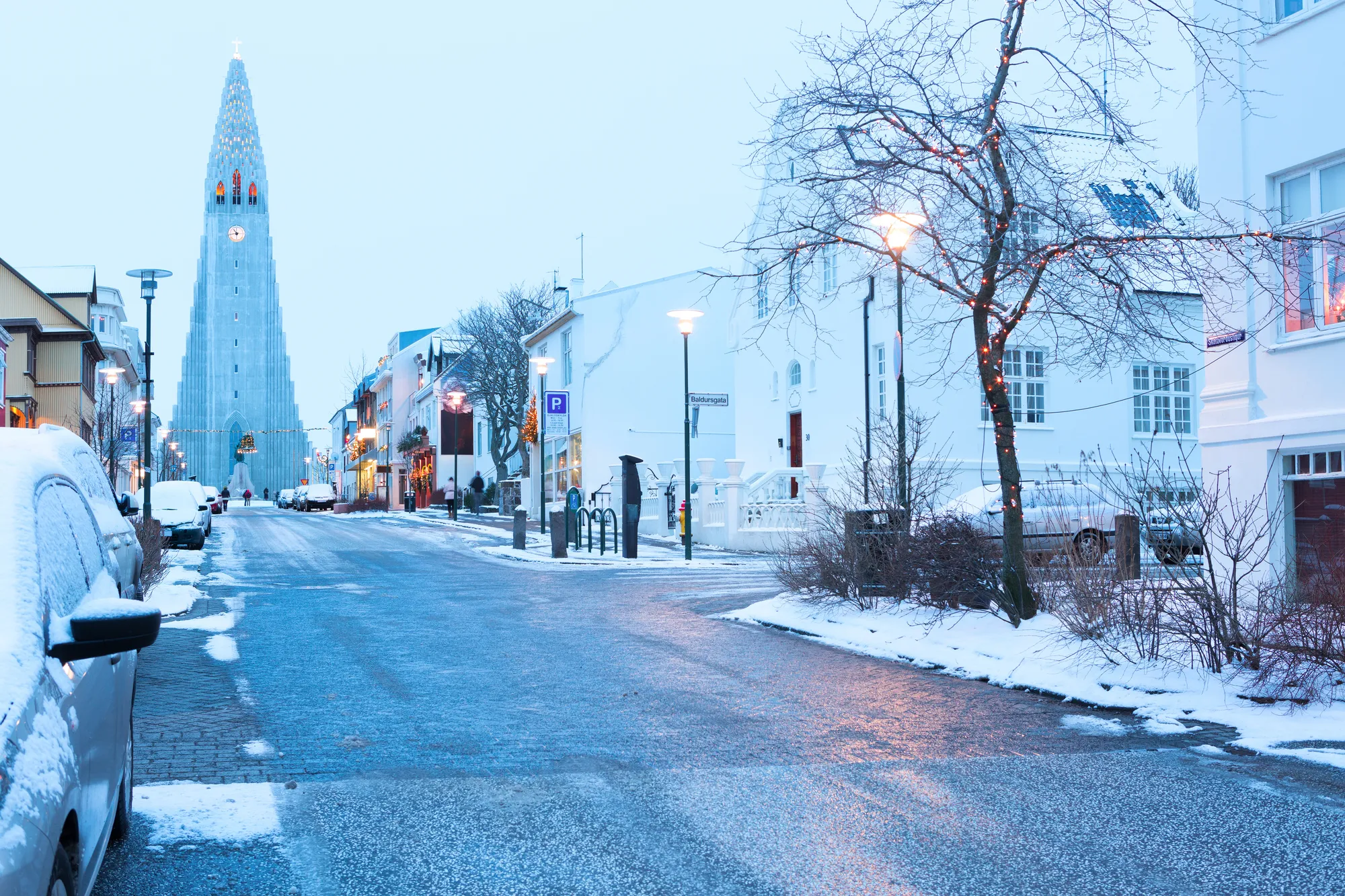 Snowy street in central Reykjavík in winter with Hallgrímskirkja church in the distance