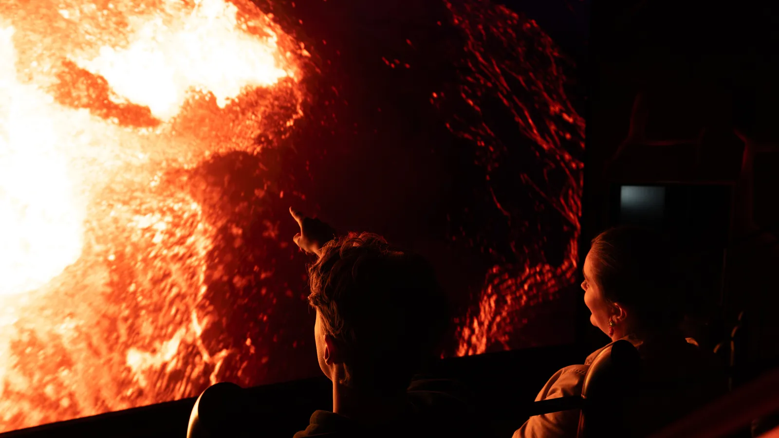 Ausbrechender Vulkan füllt den Bildschirm während der Volcano Express Bewegungsfahrt in der Harpa, Reykjavík