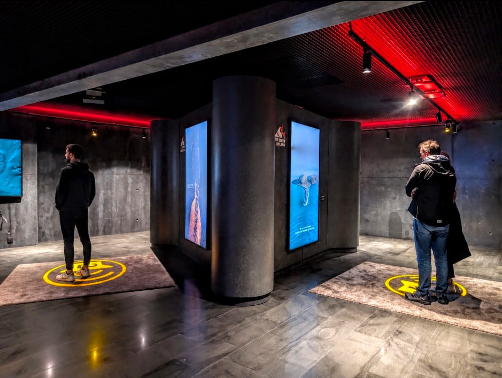 Family with young children exploring the Volcano Express pre-show area at Harpa